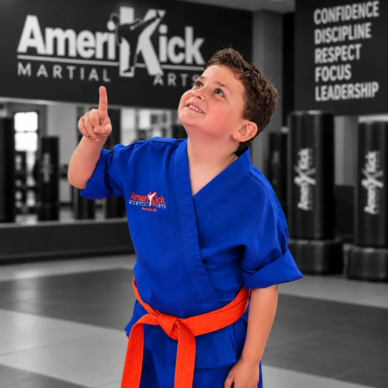 A smiling AmeriKick South Philadelphia student looking ahead with confidence